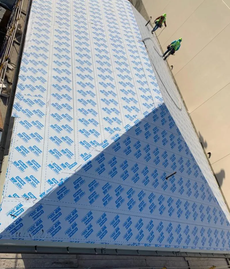 Professional roofers installing underlayment on a metal roof in Corte Madera